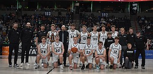 The ACH Warriors boys basketball team gathers for a team photo after receiving their fifth place trophy in the 1B state tournament.