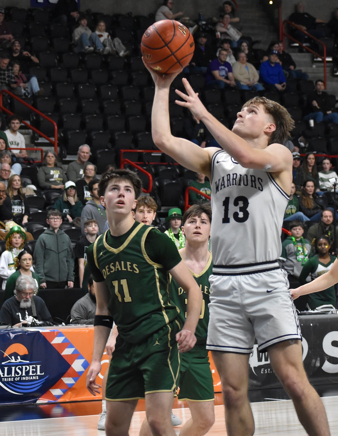 Josh Booker, a senior from ACH, leaps up to complete a layup and adds two onto the board against DeSales in the 1B state finals.