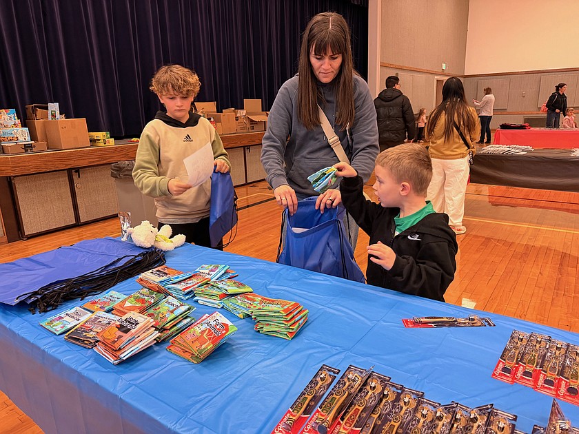 Children from the East Moses Lake Stake of the Church of Jesus Christ of Latter-day Saints make up packages Saturday for children displaced from their homes. Each package included books, a toothbrush and toothpaste, snacks and water as well as a stuffed toy and a picture contributed by a child.