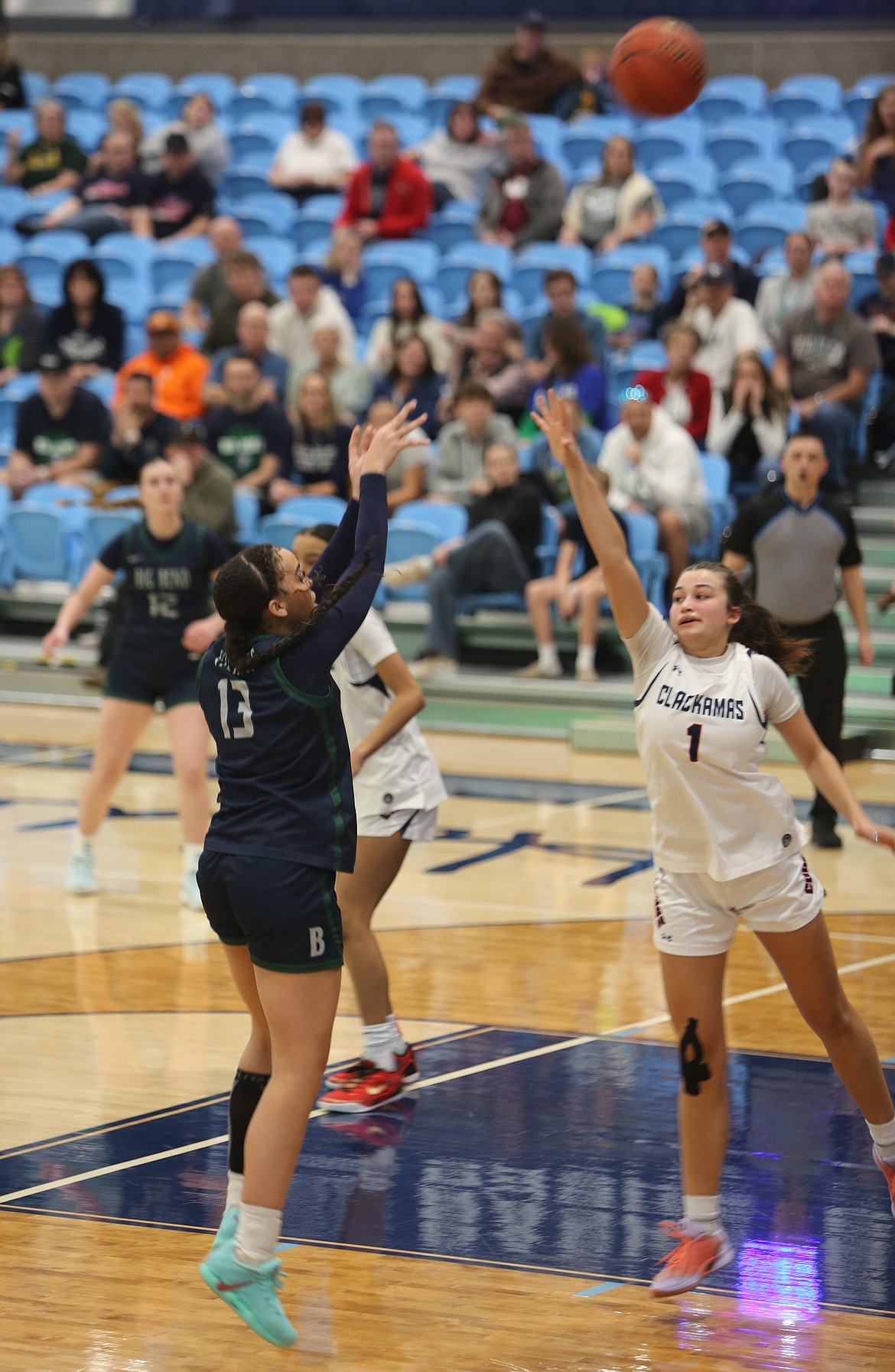 Kaliyah Evans (13) from the Lady Vikings shoots a contested shot over a Clackamas defender Saturday.