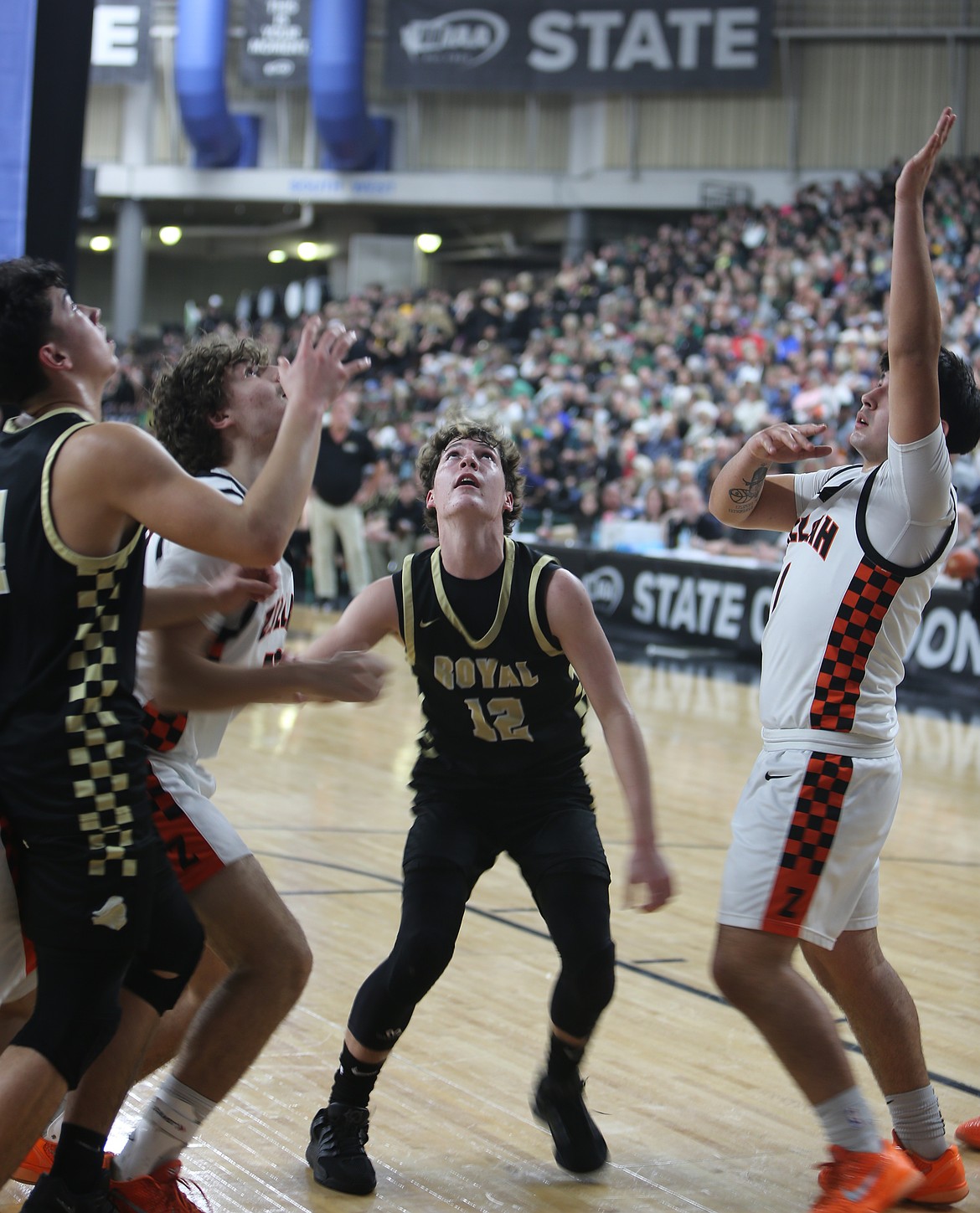 Graham Palmer (12) and Dax Jenks (4) try to outmuscle Zillah defenders as they go for the rebound in the 1A state semifinals.