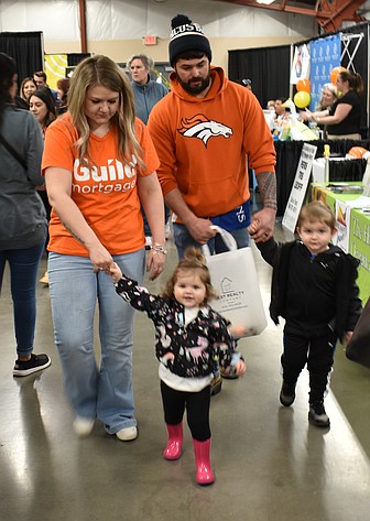 Achilles Moreno, right, and his sister Kimberlee Moreno lead their parents Ricco and Krissy Moreno around last year’s Moses Lake Business Expo. This year’s event is Tuesday.