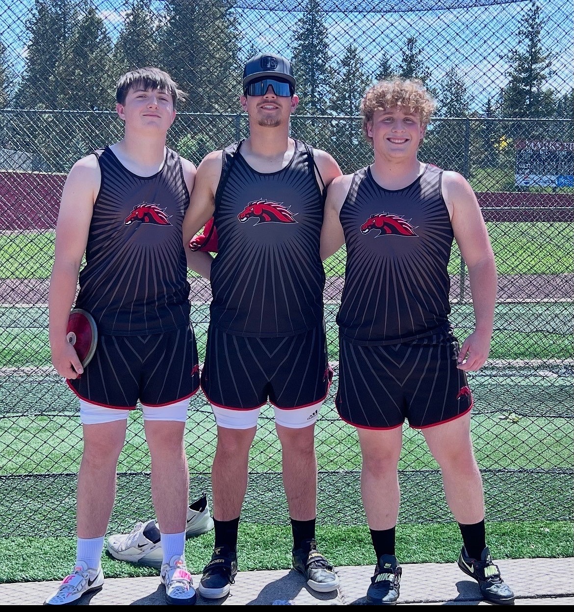 Cameron Boness, Jerod Harder and Aidan Miller from the Broncos stand together in their track uniforms ahead of the track season.