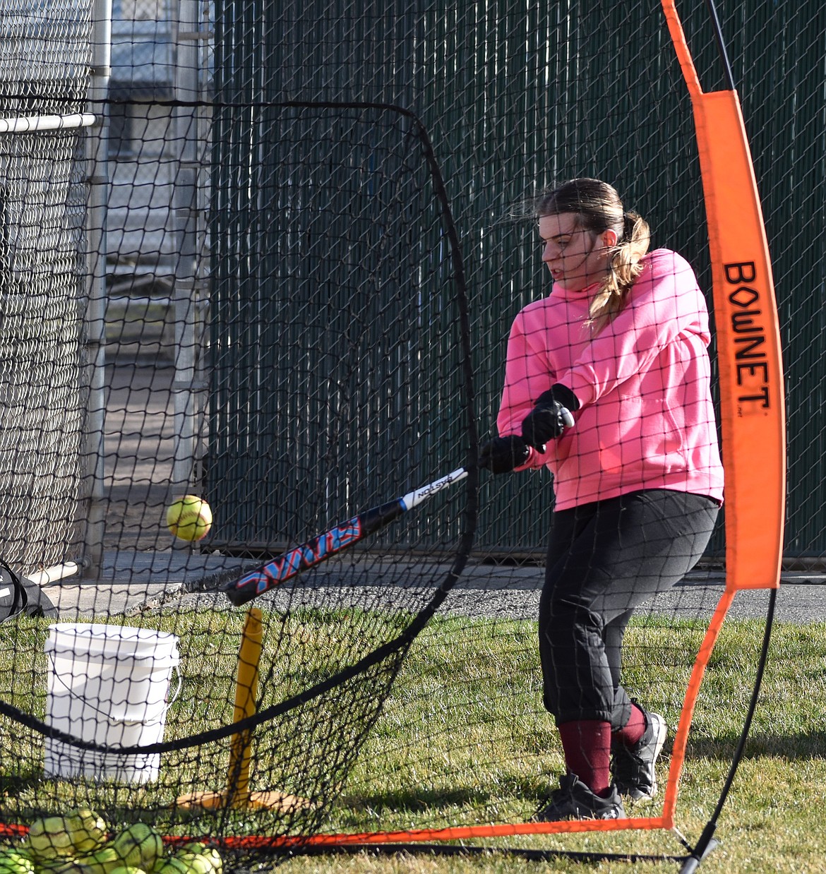 Taylor Starnes, an MLCA/CCS junior, takes a swing at the ball during practice.