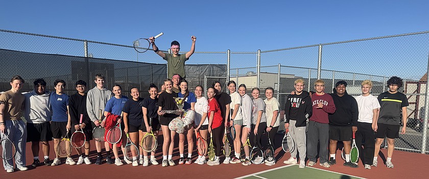 The Huskies tennis team gathers around for a team photo while celebrating senior player Faith Risenmay’s birthday during early-season practice.