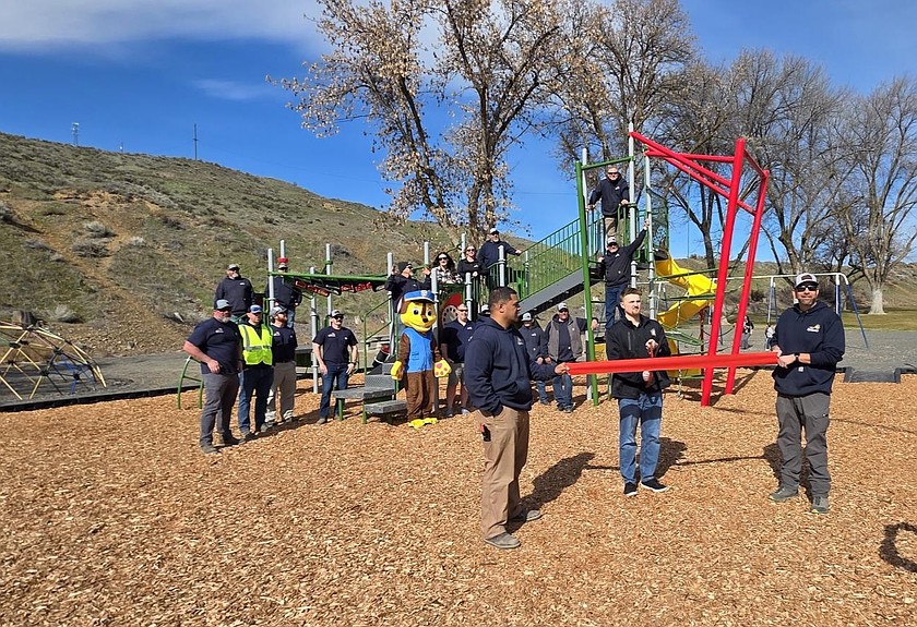 Ephrata Parks and Recreation Director Josh Johnson snips the ribbon for the city’s formal ribbon cutting opening the newly-installed playground equipment at Lions Park.