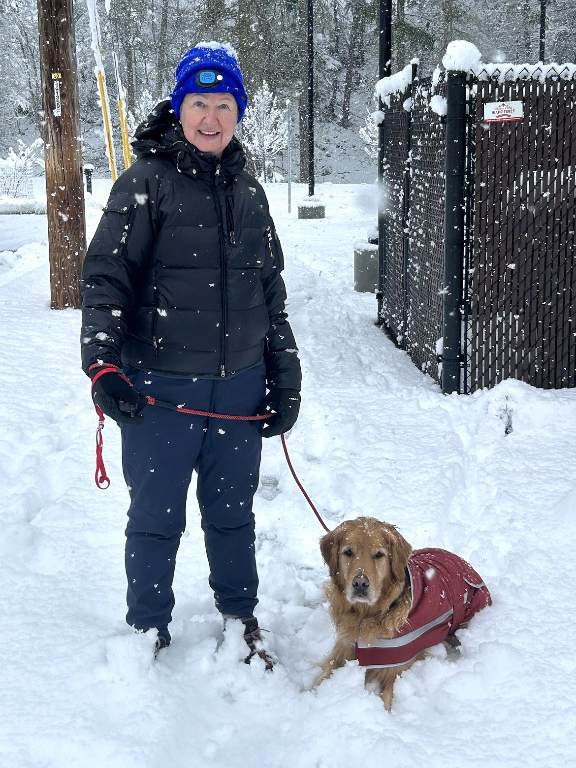 Pat Papineau and her dog Joe Vandal take a walking break in the snow near the Museum of North Idaho on Friday morning.