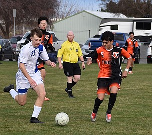 Nazar Coloborodko (23), a freshman from the Eagles, races against Diego Pichardo (6), a junior from the Tigers, for possession of the ball during the season’s opening game in Ephrata.