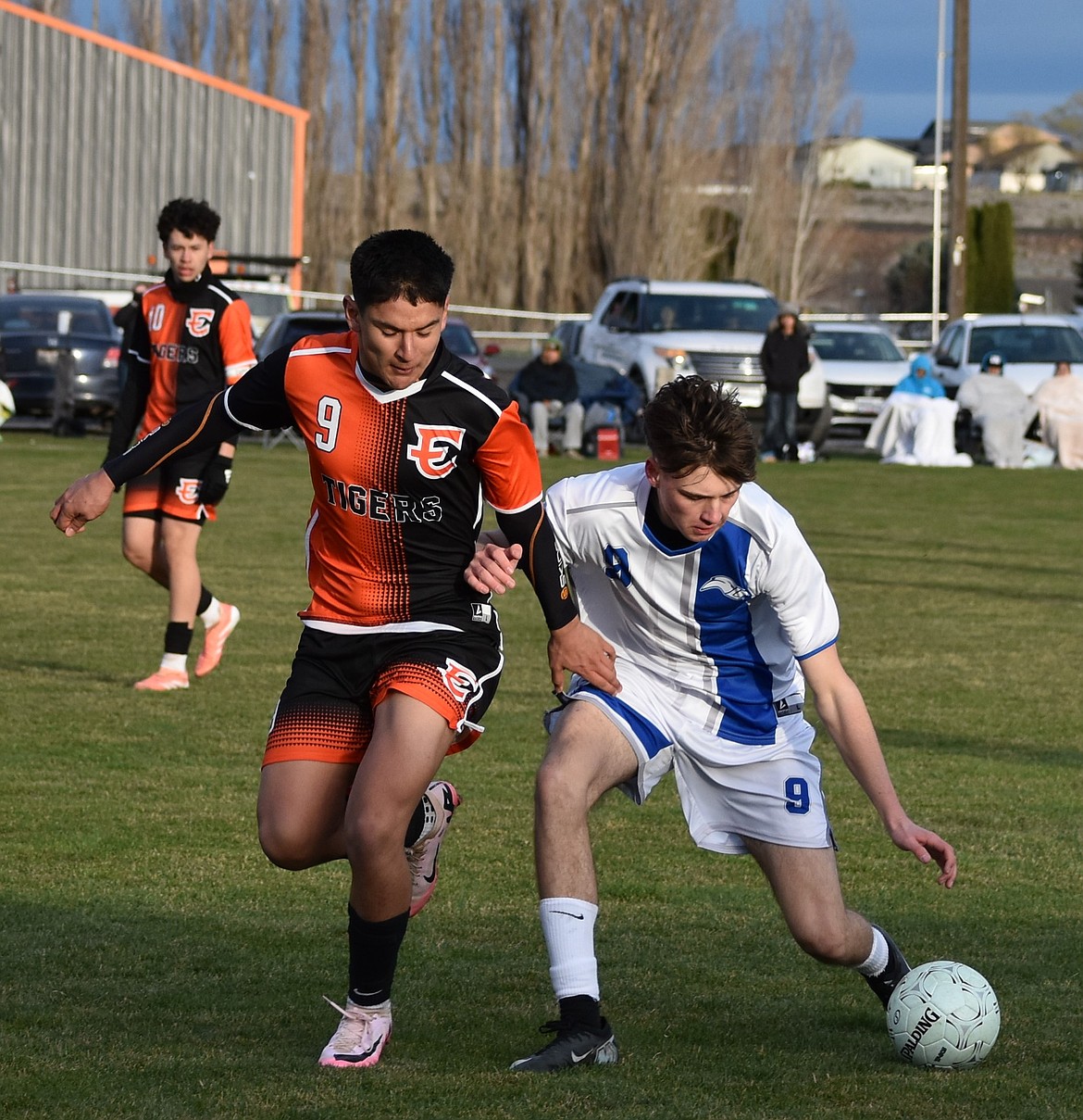 The two number nines, Yahizee Alvarado, a junior from the Tigers, and Savva Sochirca, a sophomore from the Eagles, battle along the sideline for possession of the ball.