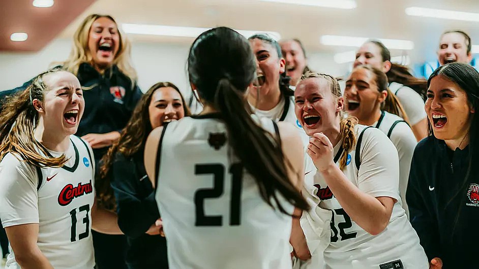The Wildcats’ Asher Cai (21) is embraced by her teammates after their 63-36 win over Montana State Billings Friday. With the win, they advanced to the second round of the NCAA Division two tournament.
