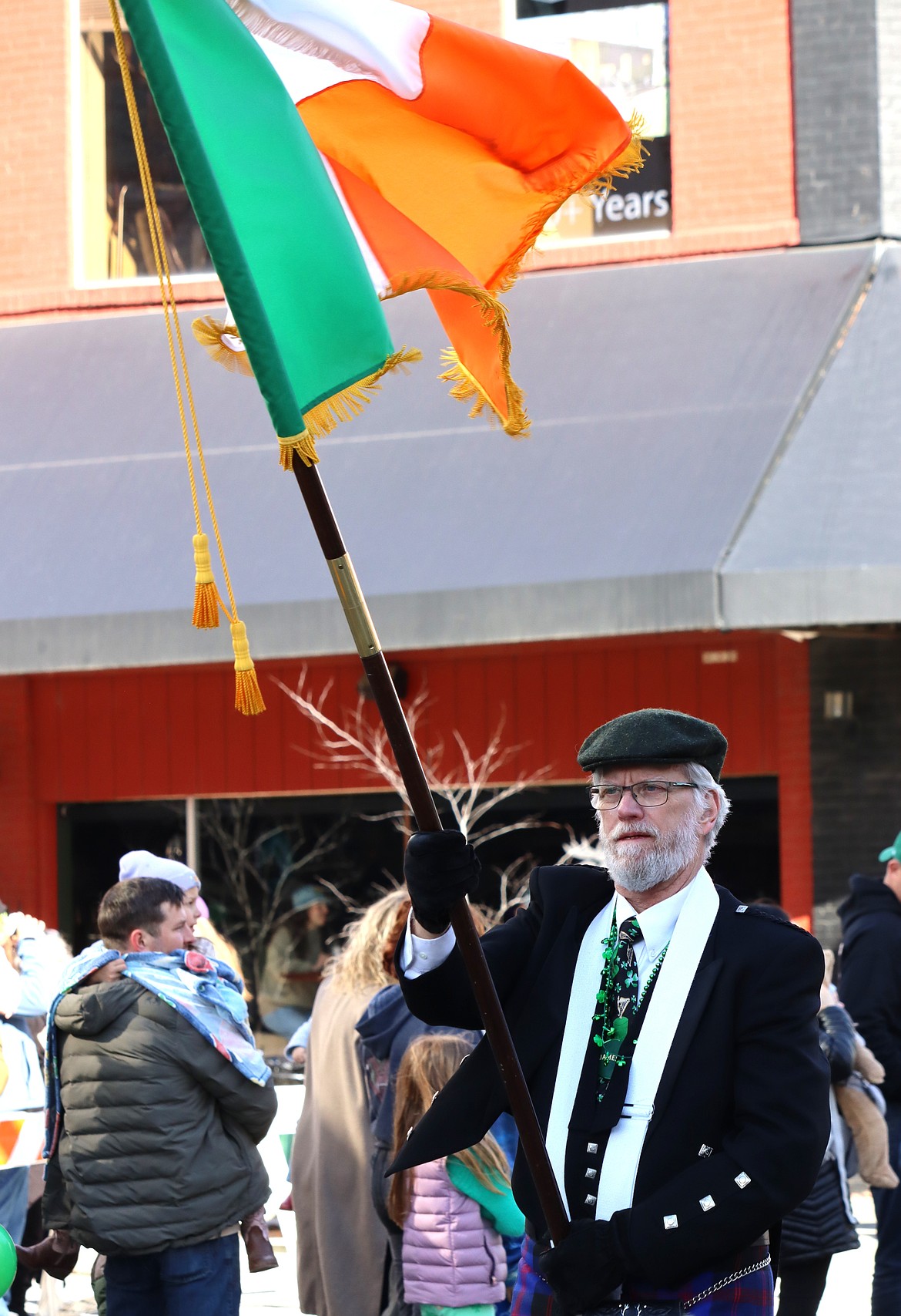 Craig Moss carries the flag of Ireland in the St. Patrick's Day parade on Saturday in downtown Coeur d'Alene.