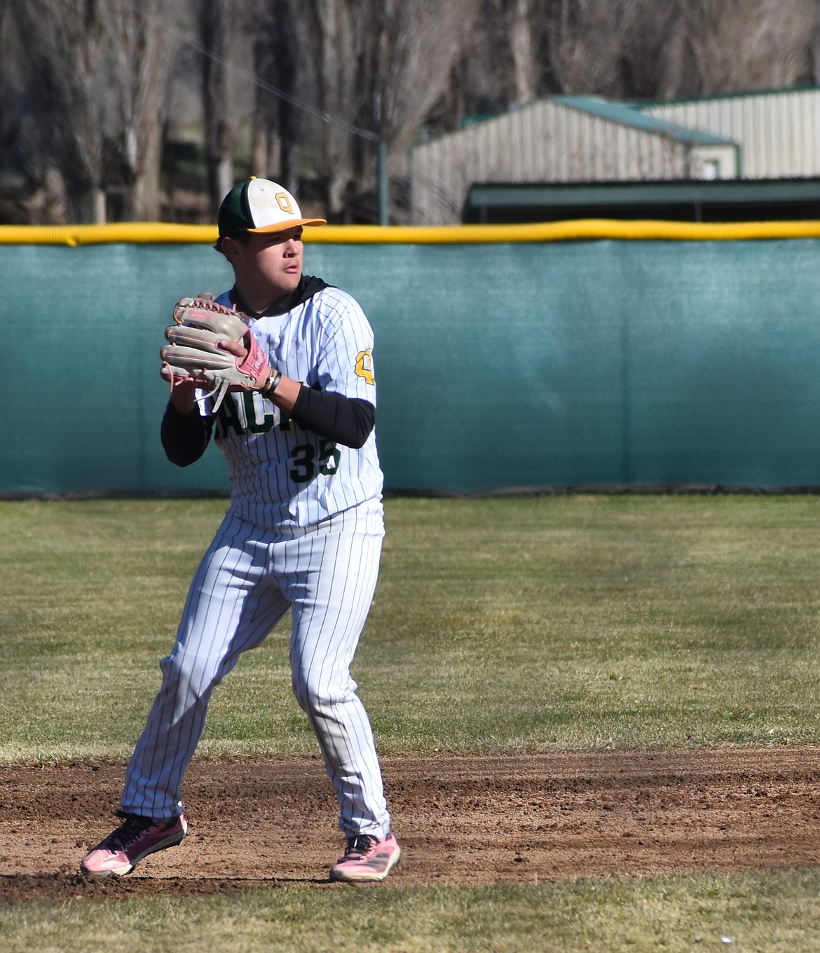 Jaxon Porter from the Jacks prepares to throw the ball to first base to get the Colville runner out.