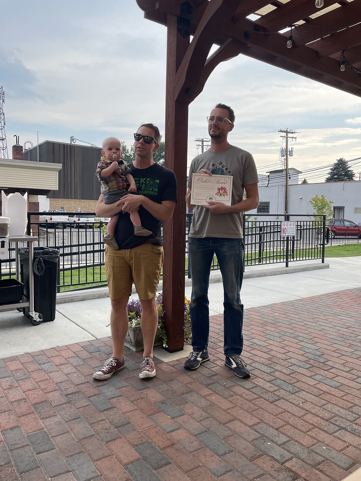 Mickey and Duffy Mahoney are pictured with the Orchid Award. The pair received the award from the state of Idaho for their renovation of the MickDuff's building, once home to the community's original federal building.