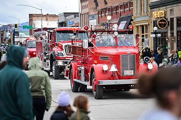 Fire trucks make their way down Main Street during the St. Patrick's Day Parade in Kalispell on Tuesday, March 17. (Casey Kreider/Daily Inter Lake)