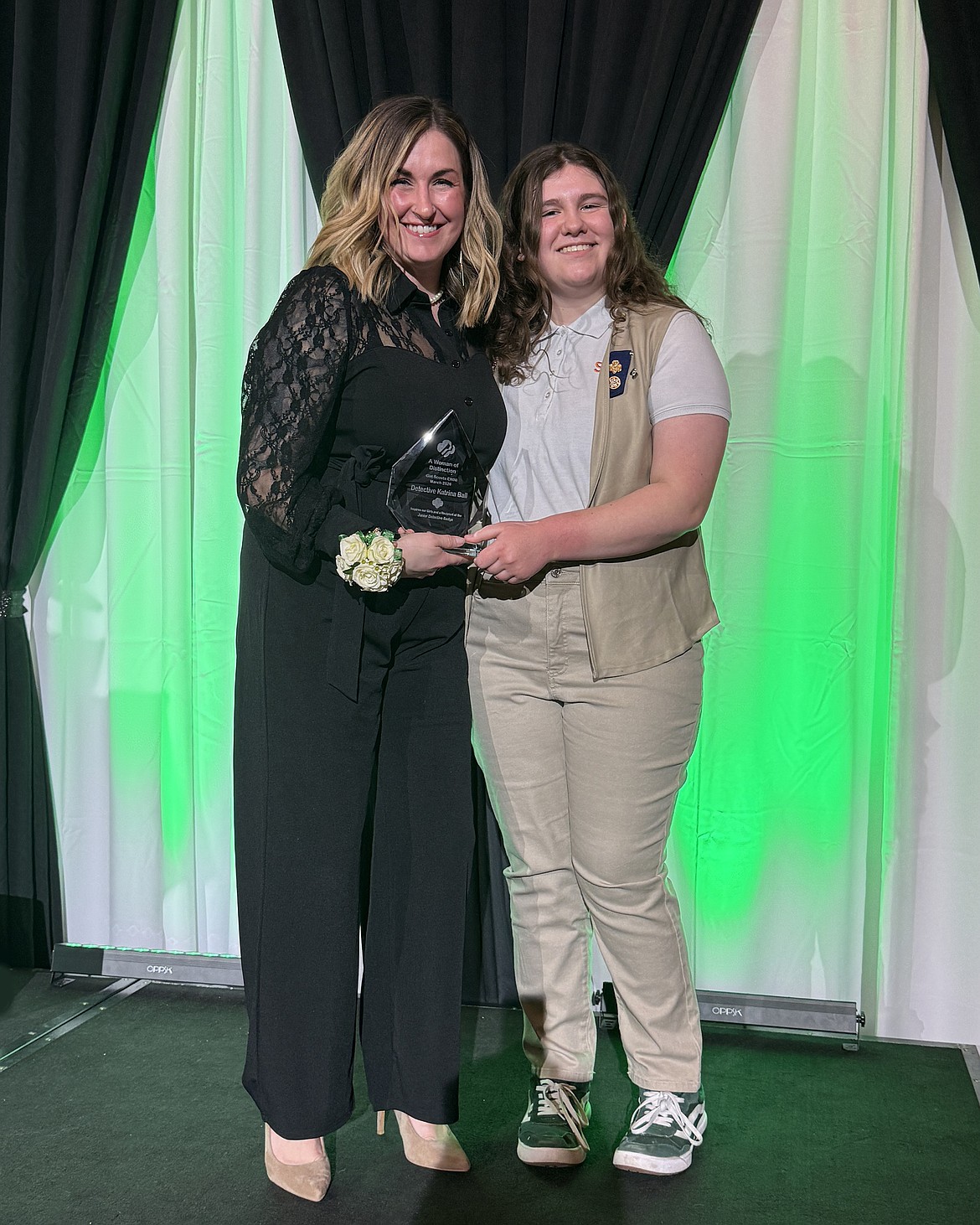 Grant County Sheriff’s Detective Katrina Ball, left, received the Woman of Distinction Award from Girl Scout Jenna Zemke, right, at the Girl Scouts of Eastern Washington and Northern Idaho Sweets Before Supper event in Spokane March 7.