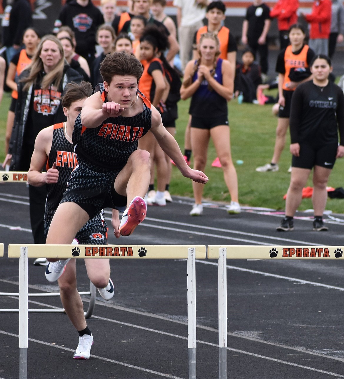 Tigers senior Maddax Iverson leaps over a hurdle during Tuesday’s meet to start the track and field season.