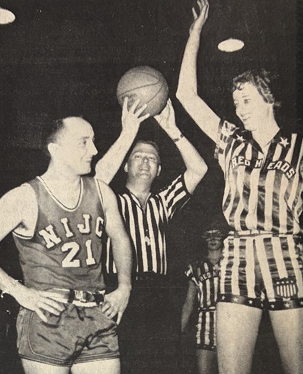 Immaculate Heart of Mary Coach Gene Boyle of the Panhandle Coaches prepares to tip off against 6-foot-3 Patty Eubanks of the all-American Red Heads in the 1966. Red Halpern of the parks and rec department referees.
