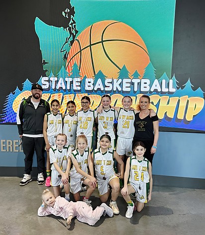 The Quincy Jackrabbits fifth-grade girls basketball team gathers for a group photo with the players wearing their third-place medals at the state tournament in Spokane.