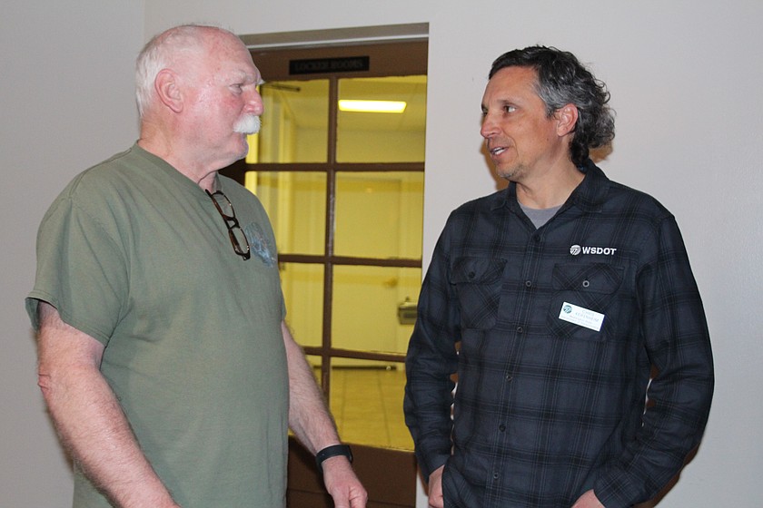 Chris Keifenheim, North Central Region director for the Washington Department of Transportation, talks to an attendee after a community meeting to discuss the replacement of the Hansen Road overpass.
