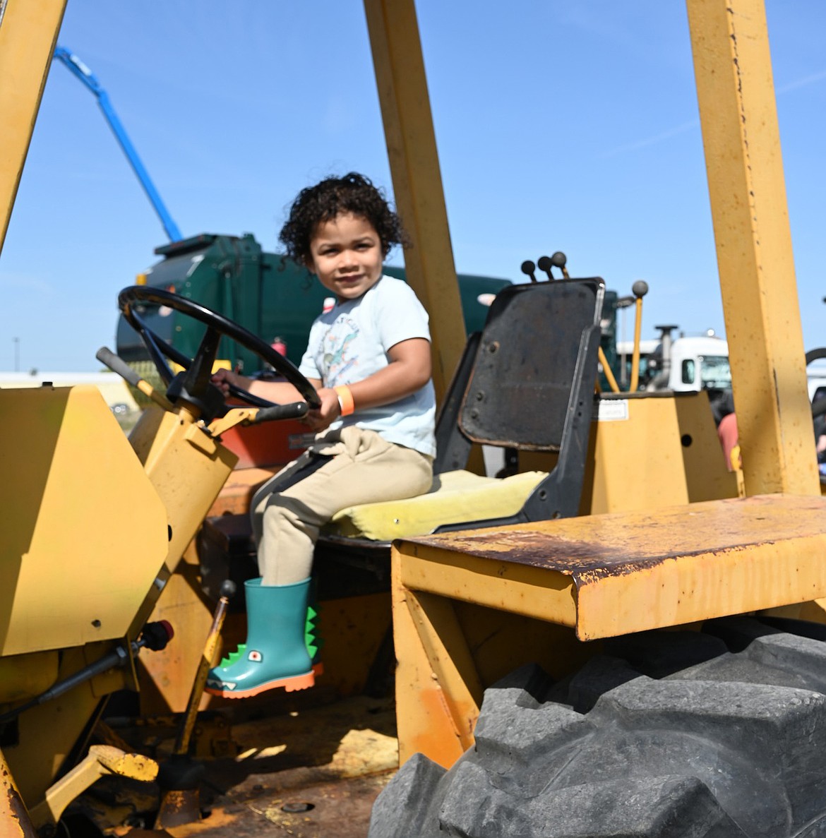 A child rides high on an excavator at last year’s Touch a Truck in Moses Lake. This year’s event is April 25.