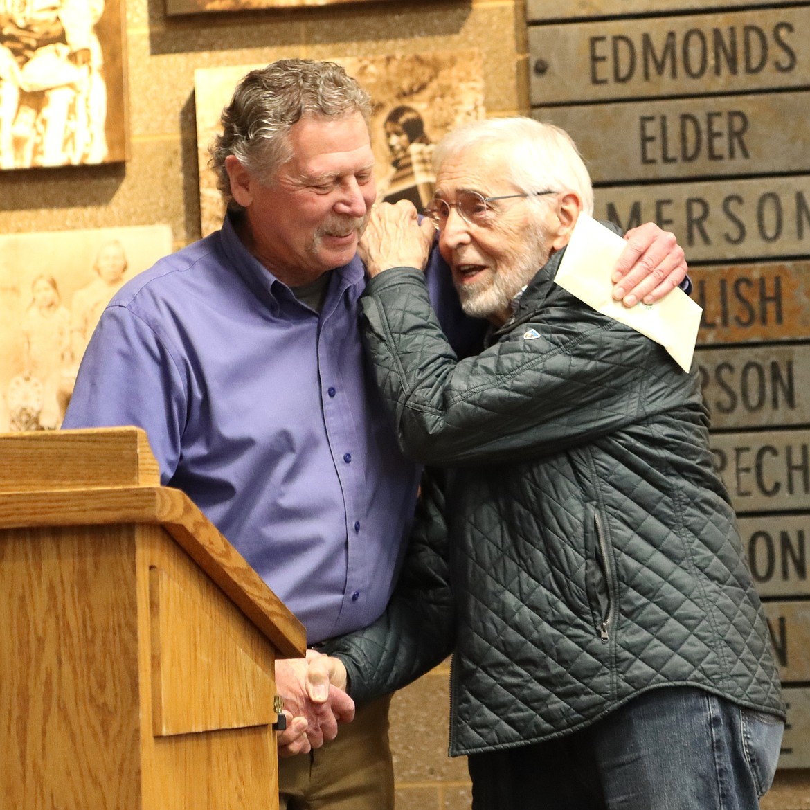 Bill Greenwood is congratulated by George Sayler during his retirement party on Friday.