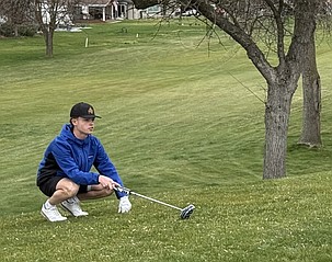Cougars sophomore Everett Cox lines up a put during the opening meet of the golf season.