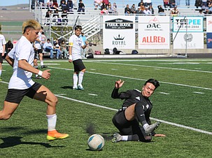 The Royal Knights’ Cristian Nieto (12) makes a slide to disrupt a Connell player during their game Saturday. The Knights eventually fell in overtime 3-2.
