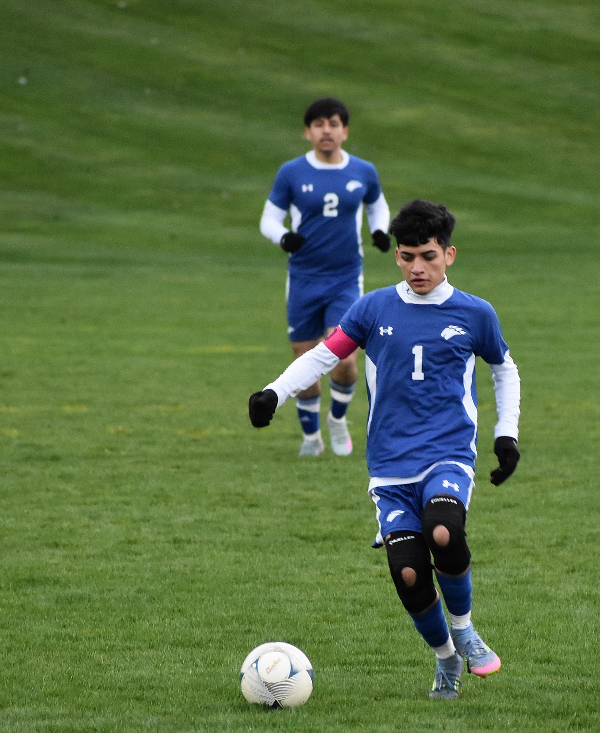 Cougars senior Brayan Chavez Garcia (1) takes the ball across the field with senior teammate Jose Mejia (2) following behind.