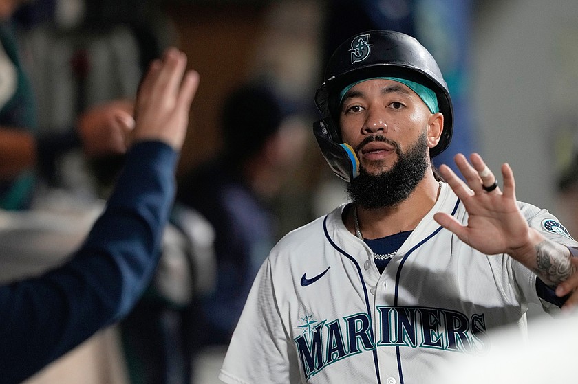 FILE - Seattle Mariners' J.P. Crawford celebrates in the dugout after scoring off a single hit by Josh Naylor during the fourth inning of a baseball game against the Colorado Rockies, Wednesday, Sept. 24, 2025, in Seattle.