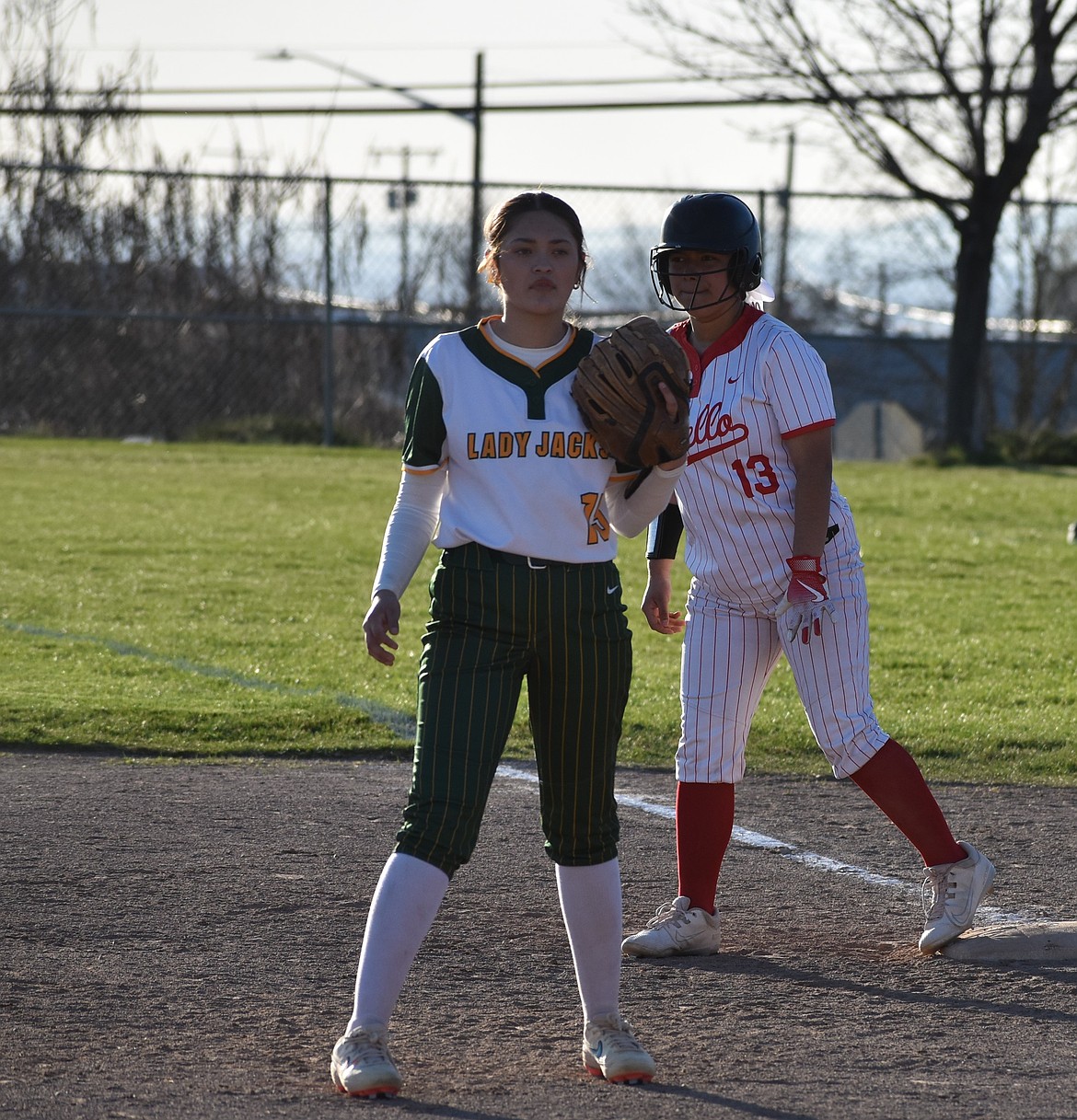 Jacks player Abril Jimenez (15) gets ready for the pitch while Huskies player Aliyah Rojas (13) prepares to make a run for second base.