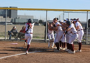 Mya Martinez (22) is greeted at home plate by her team after hitting a home run against Sunnyside Friday. The Moses Lake Mavericks defeated Sunnyside 10-0 and 19-1 in a doubleheader Friday.