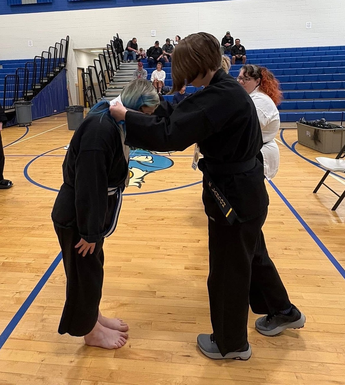 Sara Byrd, left, receives a medal at the Bruises and Babes martial arts tournament in Richland. Byrd finished second in sparring and weapons.
