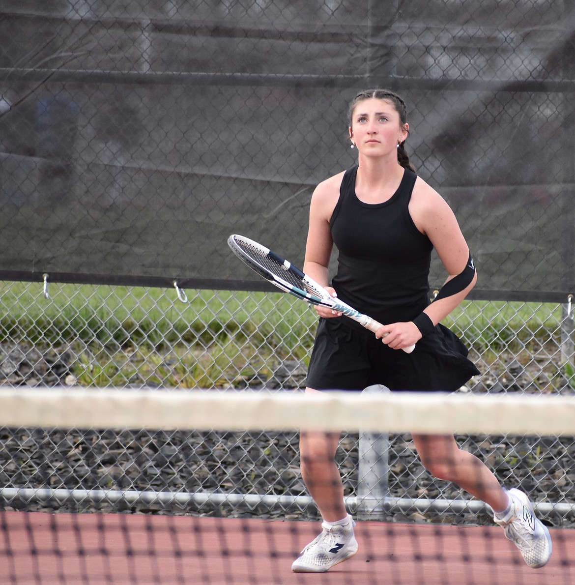 Othello senior Olivia Harris tracks the ball after a hit from the opposing Tigers player, Jillian Linehan, during Tuesday’s matchup. Olivia said she was pleased with her results after winning her matchup and is ready to continue through the season.