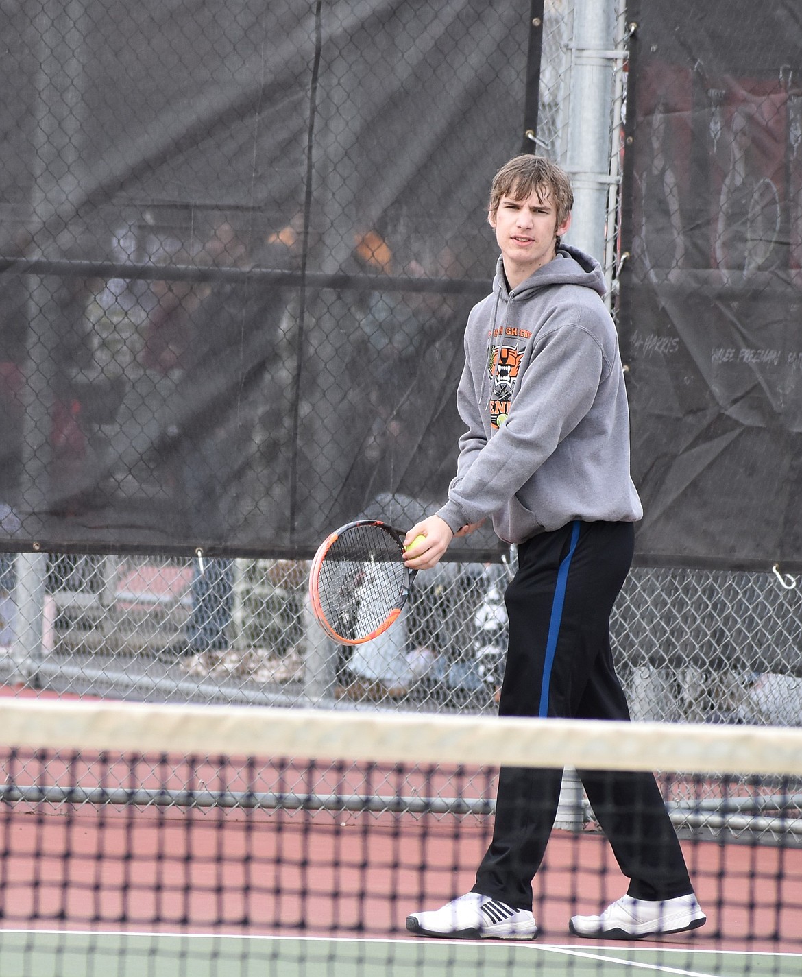 Tigers player Ben McLain prepares to serve during the number one doubles matchup against the Huskies.