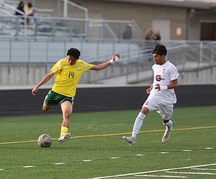 The Jacks’ Dominik Plascencia (14) goes to pass the ball as a Grandview defender closes in. The Quincy Jacks defeated Grandview 2-1 in overtime Tuesday.