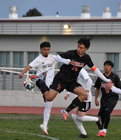 Huskies senior Luis Farias leaps in the air along with an East Valley player as they collide for possession of the ball. Farias said the Huskies knew it was going to be a competitive game, but they stuck it out and held their own.