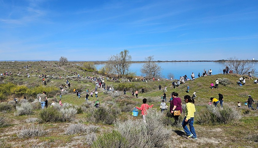 Children go across the Sand Dunes in search of eggs during the Sand Scorpions’ Easter Egg Hunt Saturday afternoon.