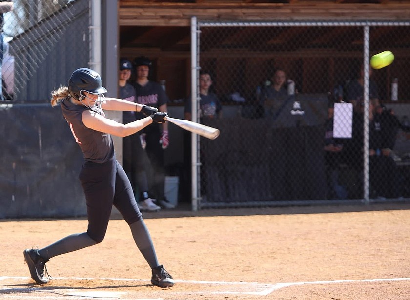 Emma Brummett from the Warriors hits the ball off a pitch from Mary Walker during Saturday afternoon’s doubleheader.
