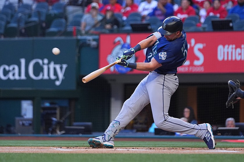 Seattle Mariners' Cal Raleigh connects on a solo home run off Texas Rangers starting pitcher Jacob deGrom during the first inning of a baseball game Monday, April 6, 2026, in Arlington, Texas.