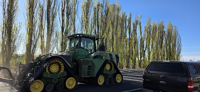 A very large farm tractor makes its way down A Street Northeast in Ephrata on an early spring morning.