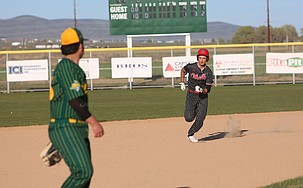 The Huskies’ Tyler Suarez (3) heads toward third after hitting the ball to the outfield. The Othello Huskies defeated the Quincy Jacks 19-1 Tuesday.