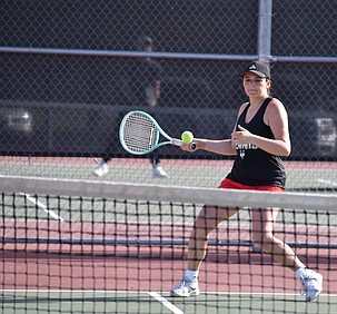Hazel Roylance from the Huskies prepares to return the ball during Wednesday’s second doubles match against Toppenish.