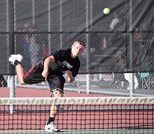Ben Meredith from the Huskies sends the ball flying across the court, back to the opposing Toppenish first doubles team Wednesday afternoon.