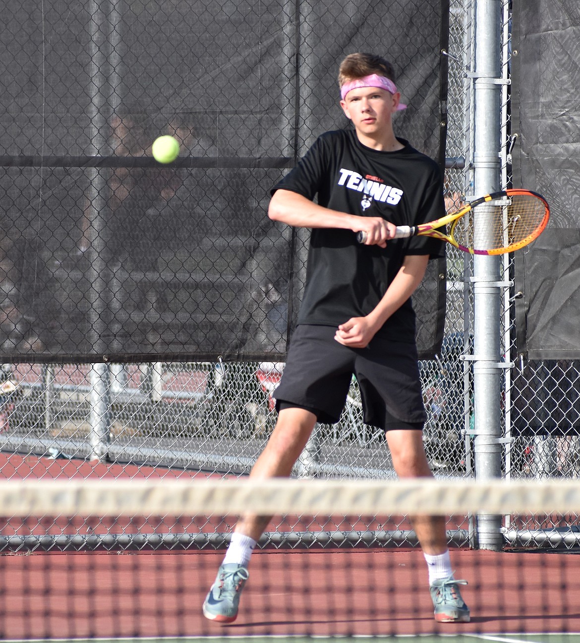 Othello’s Jace Ritchie returns the serve to the opposing first doubles team from Toppenish during Wednesday’s meet.