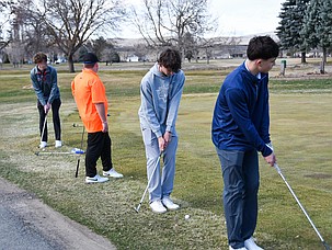 From left: Andrew Jacobson, Wyatt Hope, Cody Ogle and Jett Julian work on their swings at the driving range at the Lakeview Golf & Country Club. The Tigers finished in fifth place at a tournament in Quincy Wednesday.