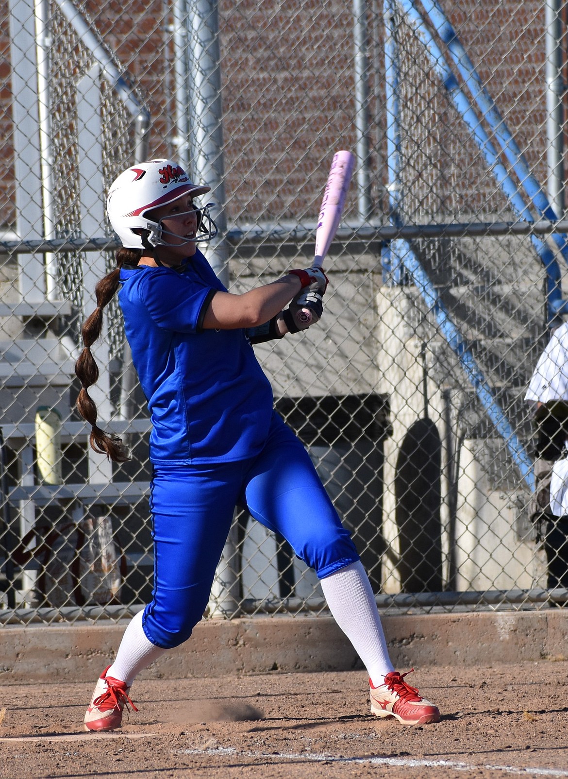 Amaya Erickson from the Cougars makes a hit and prepares to run during Thursday’s game.