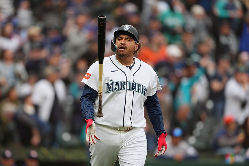 Seattle Mariners' Josh Naylor flips his bat after hitting his second home run of the game, a two-run home run during the third inning of a baseball game against the Houston Astros, Monday, April 13, 2026, in Seattle.