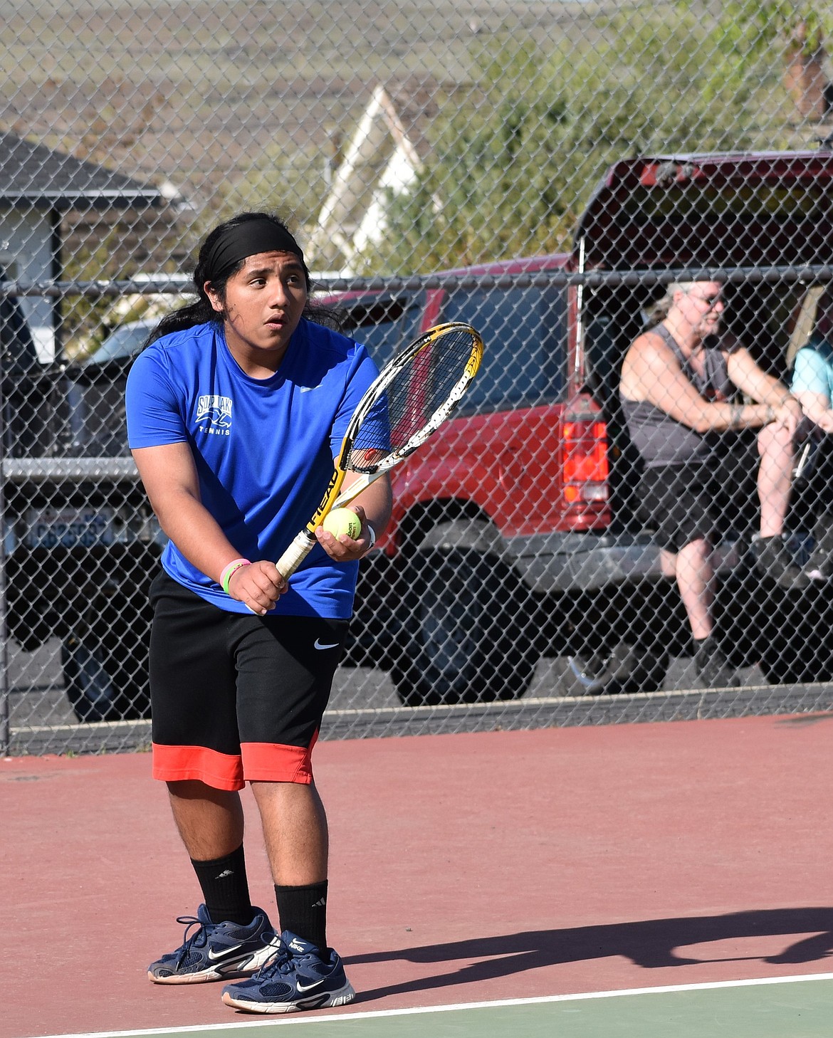 Soap Lake player, Jocsan Sanchez-Cruz serves the ball in a warmup prior to the first doubles matchup against Entiat.
