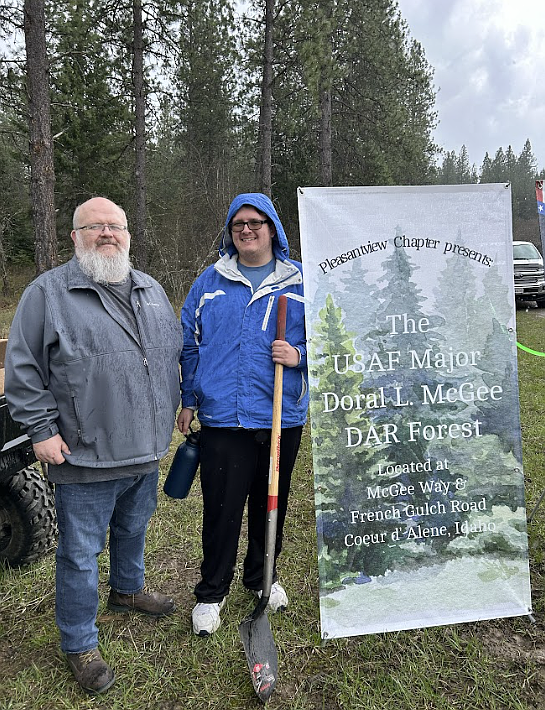 From left, Derek McGee, Army veteran and son of the late U.S. Air Force Maj. Doral McGee, plants trees Saturday with Doral's grandson, Logan McGee, as a new Daughters of the American Revolution forest is established in Coeur d'Alene to honor Doral's legacy.