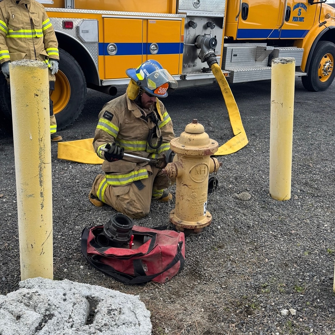 New Adams County Fire District 5 personnel train on a fire hydrant. Othello City Council members and ACFD 5 commissioners reached agreement on a contract extension through the end of 2027.